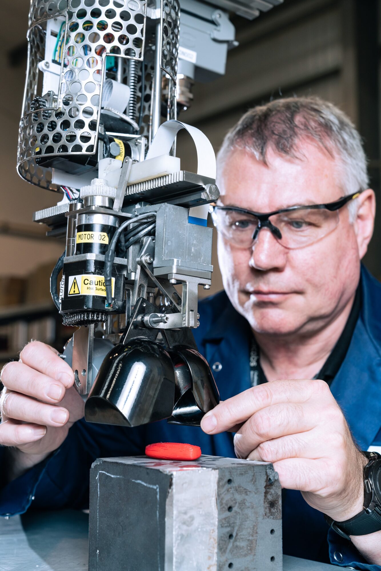 Amentum Principal Robotics Specialist Paul Reeder working on the Sand like Debris Tool